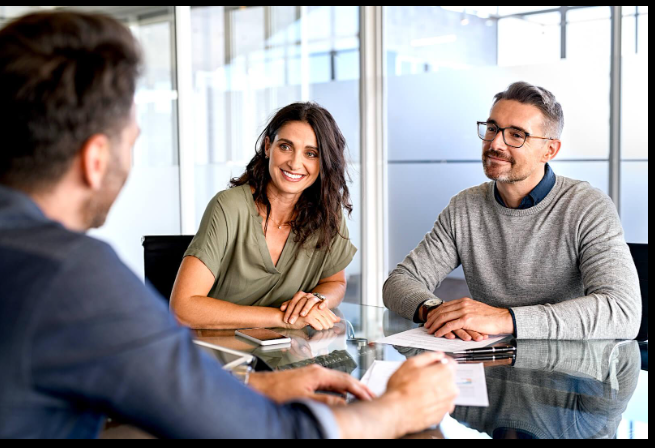 Couple reviewing property inspection with professional